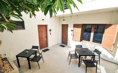 a dining room with tables and chairs and windows at Borgo Nuovo in Rhodes Town