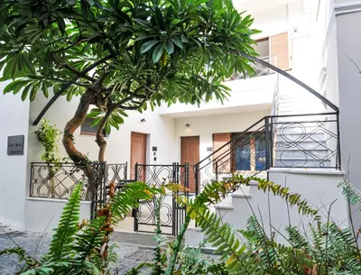 a house with a staircase and a tree in front of it at Borgo Nuovo in Rhodes Town