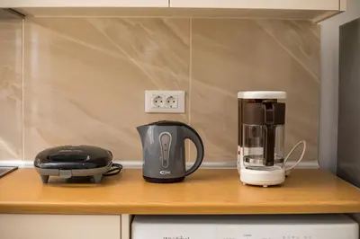 a coffeemaker and a coffee maker on a kitchen counter at VOULA APARTMENTS in Faliraki