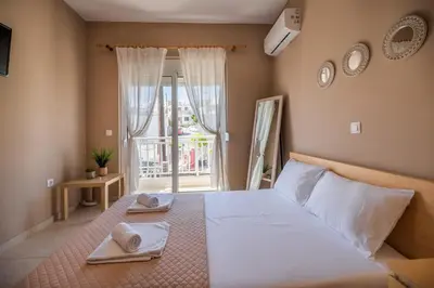 a bedroom with a large bed with towels on it at Katerina's House in Afantou