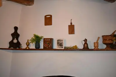 a shelf with a bunch of items on it at Lithos House in Monólithos