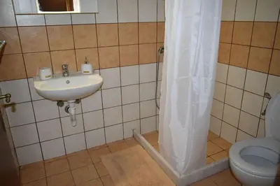 a bathroom with a sink and a toilet at Lithos House in Monólithos