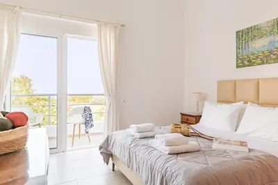 a bedroom with a bed with towels on it at Villa Thea in Afantou