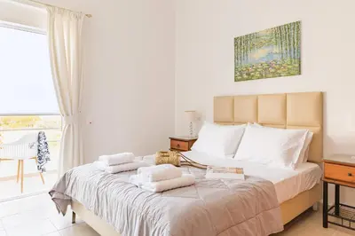 a bedroom with a bed with towels on it at Villa Thea in Afantou