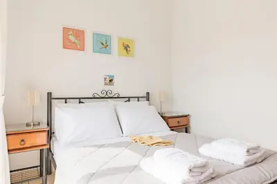 a bedroom with a white bed with towels on it at Villa Thea in Afantou