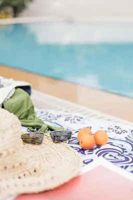 a pair of glasses and oranges on a table at Villa Thea in Afantou