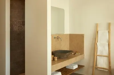 a bathroom with a sink and a mirror at Absolute Kiotari Resort in Kiotari