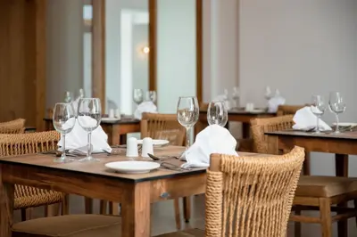 a table with wine glasses and napkins on it at Absolute Kiotari Resort in Kiotari