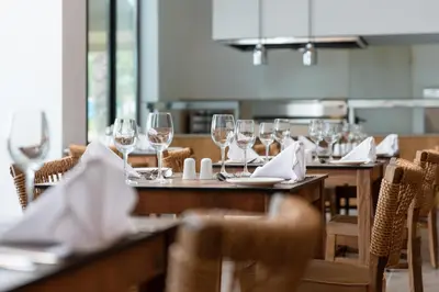 a dining room with tables with wine glasses at Absolute Kiotari Resort in Kiotari