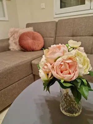 a vase filled with pink and white flowers on a table at Ma Maison Rose in Kremasti