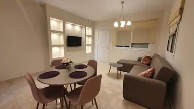 a living room with a couch and a table at Ma Maison Rose in Kremasti