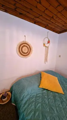 a bedroom with a green bed and a peace sign on the wall at Villa Kavalino in Kolimbia