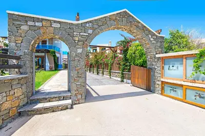 an archway in a stone building with a sidewalk at Villa Kiotari Alia in Kiotari