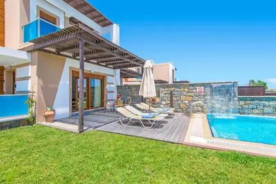 a villa with a swimming pool and a house at Villa Kiotari Alia in Kiotari