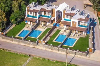 an aerial view of a house with two swimming pools at Villa Kiotari Alia in Kiotari