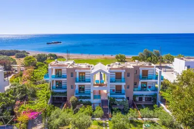 an aerial view of a building with the ocean in the background at Villa Kiotari Alia in Kiotari