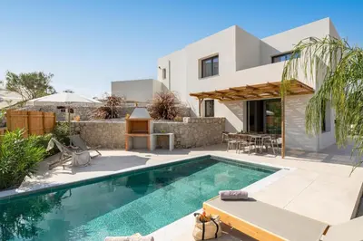 a villa with a swimming pool and a house at Massari Hills Luxury Living in Malona Village