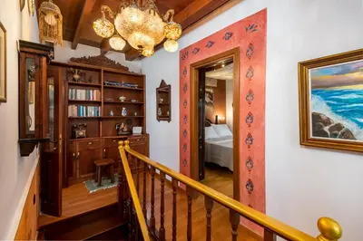 a staircase in a home with a chandelier at Mythic Spa Villa in Rhodes Town