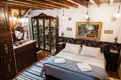 a bedroom with a bed and a dresser in it at Mythic Spa Villa in Rhodes Town