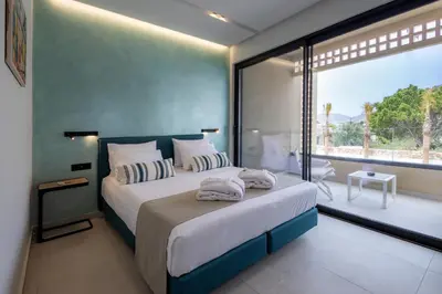a bedroom with a large bed and a large window at STALèA Luxury Villa in Pefki Rhodes