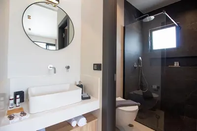 a bathroom with a sink and a mirror and a toilet at STALèA Luxury Villa in Pefki Rhodes