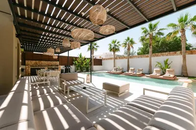 an outdoor patio with chairs and a swimming pool at STALèA Luxury Villa in Pefki Rhodes