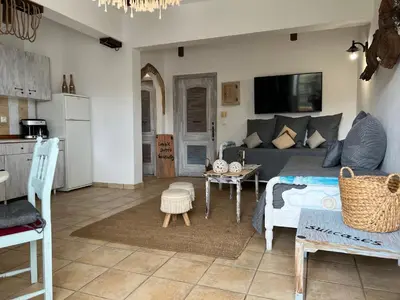 a living room with a couch and a table at ALONI G&A Archaggelos in Archangelos