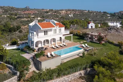 an aerial view of a house with a swimming pool at Villa Kamos in Archangelos