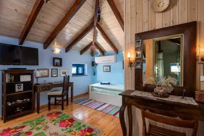 a living room with a desk and a mirror at Chalki Jewel in Halki