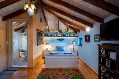 a bedroom with a bed in a room with wooden ceilings at Chalki Jewel in Halki