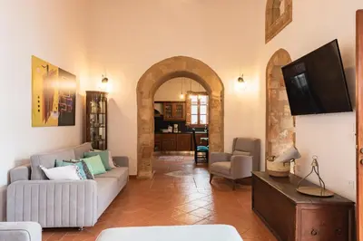 a living room with a couch and a tv at Althea Villa in Líndos