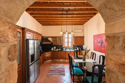 a kitchen with a table and a refrigerator at Althea Villa in Líndos