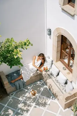 a woman sitting on a couch with a man eating food at Althea Villa in Líndos
