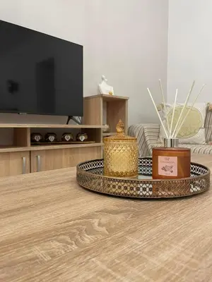 a living room with a coffee table with a tv at Villa Flora in Afantou