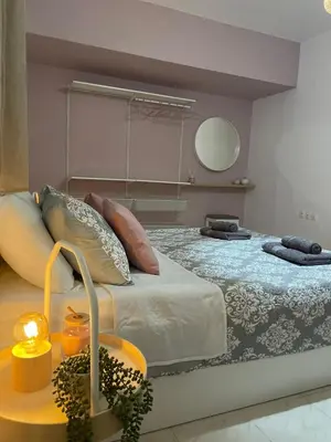 a bedroom with a large bed and a mirror at Villa Flora in Afantou
