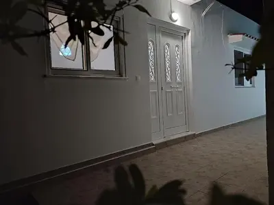 an empty hallway with a door and a window at Villa Flora in Afantou