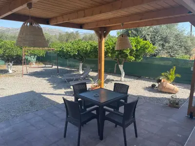 a patio with a table and chairs under a pavilion at Villa Flora in Afantou