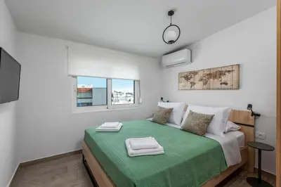 a bedroom with a bed with a green blanket at Sky High Loft in Rhodes Town