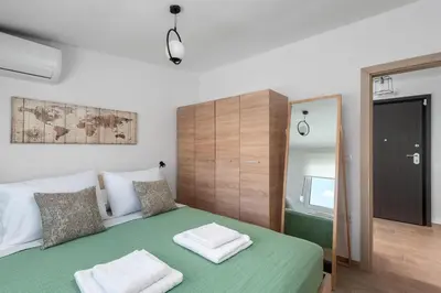 a bedroom with a green bed with two towels on it at Sky High Loft in Rhodes Town