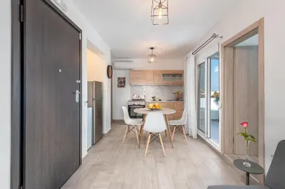 a kitchen and dining room with a table and chairs at Sky High Loft in Rhodes Town