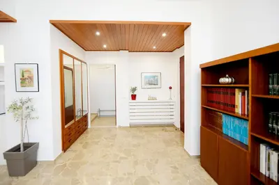 a hallway with bookshelves and a hallway with a desk at Martha's Home in Rhodes Town