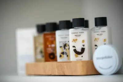 a wooden shelf with four bottles of grooming products at Dolce Casa Suite1 in Afantou