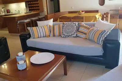 a living room with a blue couch and a table at Irene's Apartment In Salakos in Sálakos