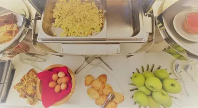 a bunch of food on a counter with plates of food at Viva Tourismo Resort (naturist club) in Paradeísion
