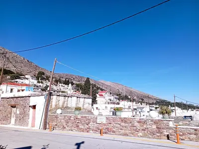 a town with white buildings on a hill at STONE GUESTHOUSE in Áyios Isídhoros