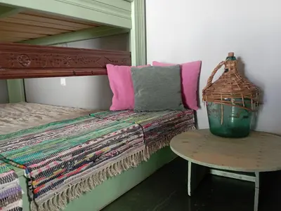 a room with a bed and a table with a basket at STONE GUESTHOUSE in Áyios Isídhoros