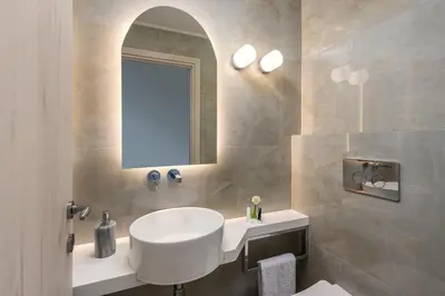 a bathroom with a white sink and a mirror at Panorama Luxury Penthouse in Ixia