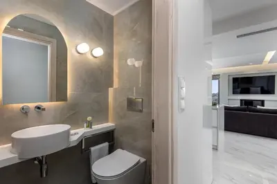 a bathroom with a white toilet and a sink at Panorama Luxury Penthouse in Ixia