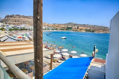 a view of the beach from a balcony of a resort at Despinas Seafront Apartments,Haraki in Haraki