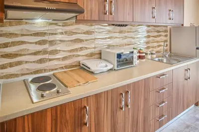 a kitchen with a counter with a toaster and a microwave at Despinas Seafront Apartments,Haraki in Haraki
